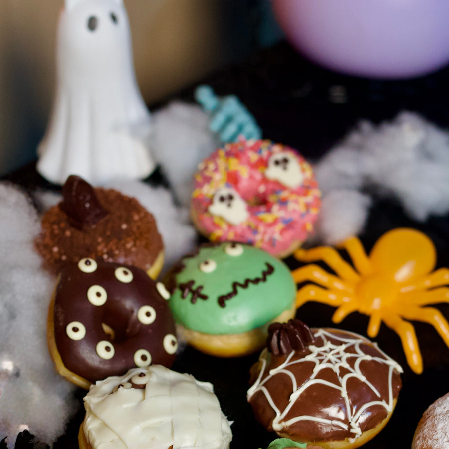 Halloween doughnuts with a ghost, a spider and cobwebs